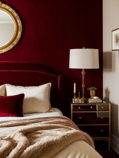 a bedroom with red walls and gold accents