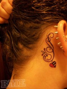 a woman with a tattoo on her ear and behind the ear is a music note