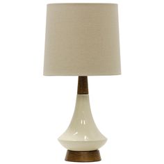 a white lamp with a beige shade on it's base and a brown wooden base