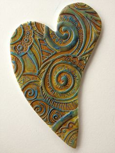 a heart shaped brooch hanging on a wall