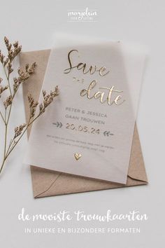 a wedding card with the words save date written on it next to some dried flowers