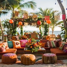 an outdoor seating area with colorful pillows and decorations