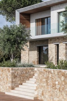 an exterior view of a modern house with stone steps