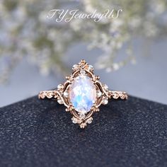 a ring with an opal surrounded by diamonds