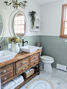 a bathroom with two round mirrors above the sink and wooden cabinet below, along with a rug on the floor