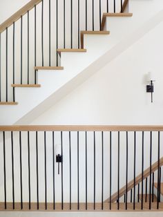 a stair case next to a banister in a house