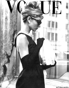 a black and white photo of a woman in a dress on the cover of a magazine