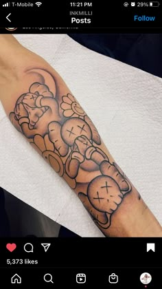 a person with a tattoo on their arm that has a clock in the shape of a teddy bear