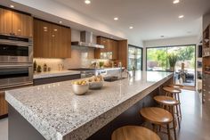 a large kitchen with wooden cabinets and marble counter tops