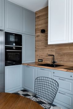 a kitchen with an oven, stove and dining table