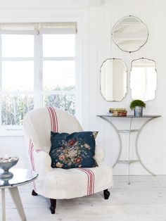 a living room filled with furniture and mirrors