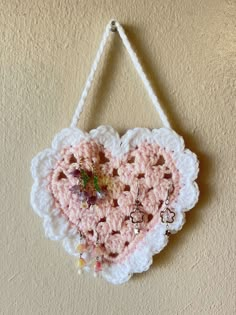 a crocheted heart hanging on the wall