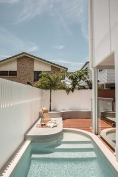 an outdoor hot tub next to a white fence