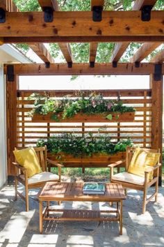 an outdoor living area with wooden furniture and plants on the pergolan roof top