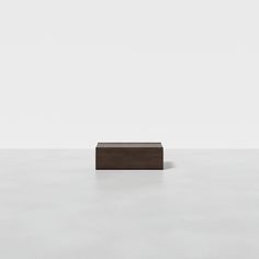 a square object sitting on top of a white floor