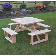 a picnic table and benches in the grass