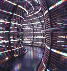 an image of a tunnel with lights coming from the ceiling and inside it that looks like something out of space