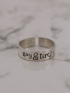 Are you gay & tired? Being gay can get a little exhausting, carrying the weight of being the most attractive, funniest, and best all-around friend and sibling. Product Details: Materials: Aluminum, Sterling Silver, Fine Silver, 14k Gold Filled Color: Silver, Gold, Rose Gold Size: 6mm You will receive one hand-stamped ring filled with a black enamel finish. Gay Rings, Stamped Ring, Hand Stamped Ring, Stamped Rings, Black Enamel, Fine Silver, Gold Rose, Hand Stamped, Silver Gold