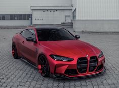 a red sports car parked in front of a building