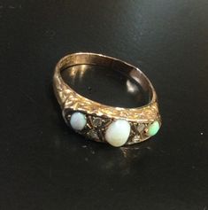 9ct rose gold ,hallmarked Chester 1921  Victorian style carved half hoop ring . Set with oval opals and old cut chip diamonds . It has a solid back ,so I can't see the back of the stones . Size S     USA 9  A nice vintage ring .  There is a faint hairline on the middle Opal. Priced accordingly. If you put your email in the notes , i will add it to the tracking details. Uk customers can use a mobile number. Victorian Oval Opal Ring Hallmarked, Victorian Style Oval Opal Ring With Hallmark, Victorian Style Oval Opal Ring Hallmarked, Antique Oval Multi-stone Opal Ring, Victorian Three Stone Oval Ring, Antique Multi-stone Opal Ring For Anniversary, Victorian Oval Opal Ring For Anniversary, Opal And Diamond Ring, Gold Amethyst Ring