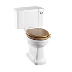 a white toilet with a gold lid and seat cover on the tank, in front of a white background