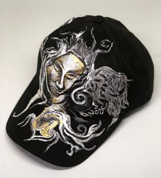 You are viewing a one of a kind handpainted suede baseball cap from the avoir studio. The cap features a painting of a praying angel with wings on the suede base. This cap is black suede. Other colors are available as are custom orders, but each painting is done by hand and truly unique.  Caps are available in black, charcoal, pink and blue. The painting is done in acrylic-based textile fabric paint that is water resistant and will withstand the rain as well as a wipedown with a wet cloth.  Howe Artistic Adjustable Snapback Baseball Cap, Artistic Adjustable Black Hat, Artistic Black Adjustable Hat, Custom Black Baseball Cap With Curved Brim, Artistic Black Cap, Black Adjustable Artistic Hat, Adjustable Black Artistic Hat, Distressed Black Dad Hat Baseball Cap, Black Distressed Baseball Cap For Streetwear