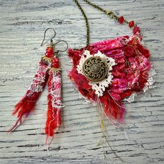 a red and white purse with two tassels hanging from it