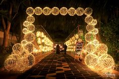 a walkway covered in lots of lights and balls