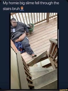 a man sitting on top of a wooden stair case