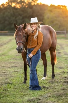 a woman standing next to a brown horse