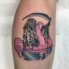 a tattoo on the leg of a person with a pink flamingo in an inflatable raft