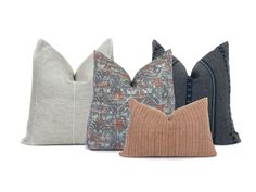 four pillows in different colors and patterns on a white background, each with a decorative pillow