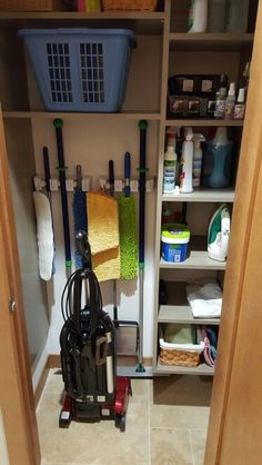 the closet is full of cleaning supplies and other household items, including a vacuum cleaner