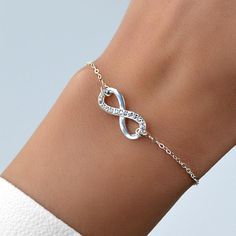 This simple, but elegant chain bracelet is beautifully delicate and features an Infinity Symbol. It's the perfect gift for your best friend, your mom, girlfriend, or even yourself! Wear the Crystal Stainless Steel Infinity Bracelet as your daily affirmation, inspiration, and reminder, that you are loved! This quality bracelet is crafted of hypoallergenic stainless steel. It's completely adjustable and can be fitted to most wrist sizes. Show your love with this beautiful Crystal Infinity Bracelet Minimalist Alloy Chain Bracelet As Gift, Minimalist Alloy Chain Bracelet Gift, Minimalist Alloy Charm Bracelet Gift, Trendy Infinity Jewelry, Trendy Infinity Jewelry Gift, Trendy Infinity Jewelry For Gift, Elegant Mother's Day Party Charm Bracelet, Elegant Infinity Jewelry For Friendship, Friendship Infinity Metal Jewelry