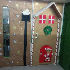 a door decorated to look like a gingerbread house with decorations on the front and side