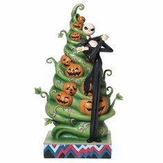 a figurine is standing on top of a halloween tree