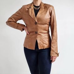 Stunning vintage blazer jacket made from genuine leather in tan brown. It has a fitted shape, a v-neck collar, long sleeves with slits and two buttons fastening. Comes fully lined. This smart and timeless jacket is perfect wardrobe staple! Made by Gaffa & Co. in England. Outer: 100% genuine leather. Lining: 100% polyester. No size label, would fit a Small size. Measurements when laid flat are: Pit to pit: 48cm  Waist: 39cm Hemline: 47cm Length: 62cm Sleeve length: 62cm. Excellent condition, apar Fitted Vintage Brown Leather Jacket, Fitted Brown Leather Jacket With Lapel Collar, Formal Fitted Brown Leather Jacket, Fitted Cognac Outerwear For Work, Vintage Brown Classic Leather Jacket For Work, Classic Vintage Brown Leather Jacket For Work, Vintage Brown Blazer For Office, Cognac Leather Jacket For Work, Brown Leather Jacket With Notch Lapel For Spring