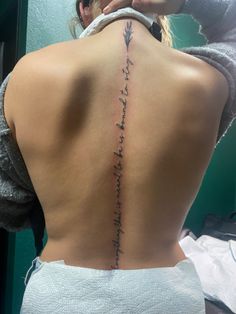 the back of a woman's neck with words written on it and an arrow