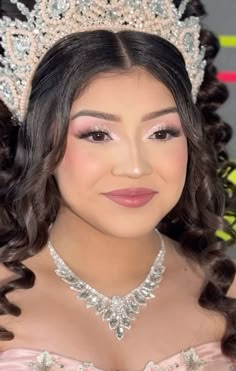 a woman wearing a tiara and smiling at the camera