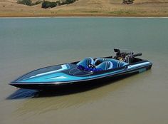 a blue and black speed boat in the water