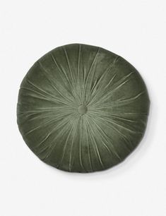 a green round cushion on a white surface