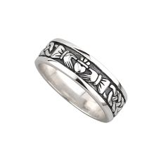 a wedding ring with an intricate design on the outside and inside, in sterling silver