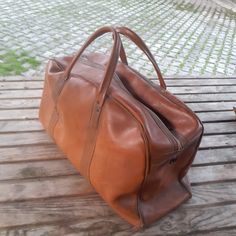 Vintage luggage 1950s -60s. It is in perfect condition. Zipper functioned. Wooden base inside.    Charcteristic tan color. Rare.Ready to use. Measurements; Width: 15 cm  (  5.91  inch ) Height: 28 cm ( 11.02  inch ) Length: 47 cm  ( 18.5 inch ) Paypal is the SOLO payment method at HUNTECLECTIC,  If you prefer to checkout with CREDIT CARD,just let us know so we can direct your order to our other shop where ETSY PAYMENTS İS AVAILABLE! All orders will be shipped within 1-3 business days . Estimated arrival time for EU is app. 3-7 days Estimated arrival time for USA,is app. 15-25 business days depending on the state. If you prefer express shipping please let us know,so we can offer a new shipping fee for you. Thanks for your kind interest! Vintage Leather Travel Bag For Formal Use, Vintage Brown Luggage For Everyday Use, Vintage Brown Luggage For Trips, Brown Travel Bags, Vintage Rectangular Travel Bag For Everyday, Vintage Brown Travel Bag With Luggage Sleeve, Vintage Cognac Briefcase For Travel, Vintage Brown Travel Bag For Everyday, Vintage Satchel Travel Bag For Business