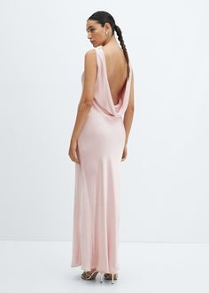 a woman in a pink dress looking back