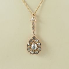 A very beautiful antique Victorian 14K rose gold and rose cut diamond pendant with clip fastening. The teardrop shaped pendant with a large teardrop shaped rose cut diamond, circa 0.5-0.7 carat, 6mm x 5mm, in a bezel and prong setting, with a surround of nine circular rose cut diamonds, each circa 0.05 carat, 3mm in diameter, in bezel settings. The diamonds in a closed back setting and foiled to enhance the brilliance. With a swagged pierced gallery. On a marquise shaped drop with three very fla Antique Rose Cut Diamond Wedding Necklaces, Antique Rose Gold Diamond Jewelry, Antique Rose Gold Jewelry With Single Cut Diamonds, Antique Rose Gold Jewelry With Diamond Accents, Victorian Rose Gold Jewelry With Single Cut Diamonds, Antique Teardrop Rose Cut Diamond Jewelry, Victorian Rose Gold Necklaces For Wedding, Victorian Rose Gold Wedding Necklaces, Victorian Teardrop Wedding Necklace