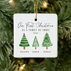 a personalized ornament hanging from a christmas tree with three trees on it