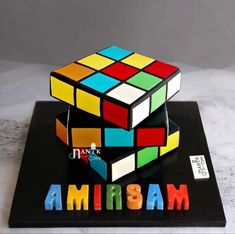 a cake made to look like a rubik cube with the word amissam on it