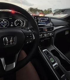 the interior of a car with dashboard lights and steering wheel