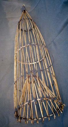 a bamboo birdcage sitting on top of a blue sheet