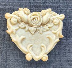 a heart shaped cookie with a rose on it